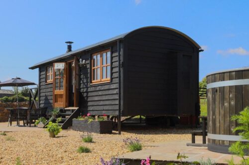 A traditional black shepherds hut in Cornwall near Looe