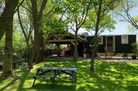 A shepherds hut surrounded by trees