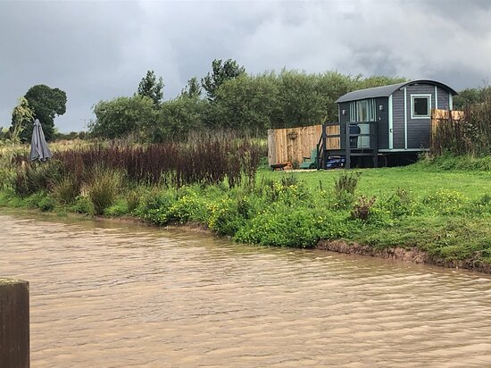 Golborne Caravan Park Shepherds Hut, nestled on the edge of a lake