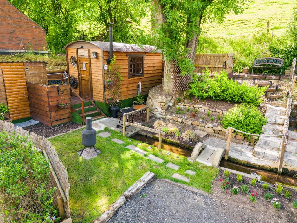 The old pump house shepherds hut and garden. A wooden shiplap hut